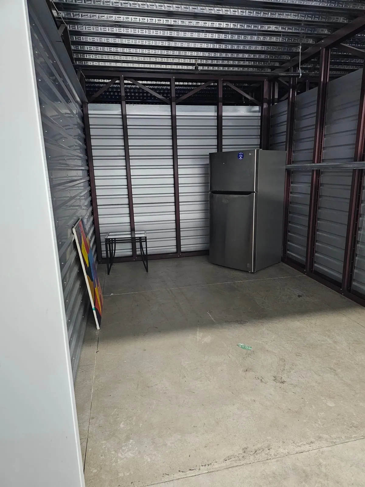 Storage unit holding a refrigerator and stacked household goods